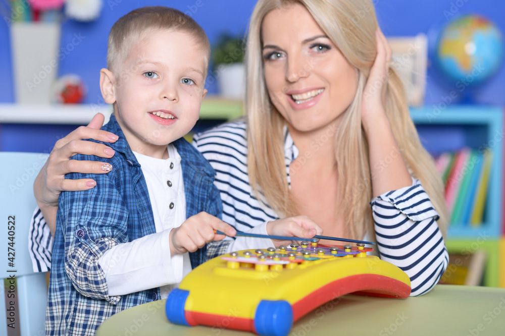 Young mother and cute little son playing Young mother and cute little son playing