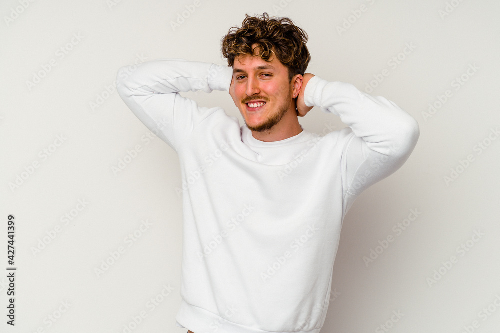 Young caucasian man isolated on white background feeling confident, with hands behind the head. Young caucasian man isolated on white background feeling confident, with hands behind the head.
