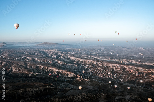 TURKEY, CAPPADOCIA, GOREME: Aerial scenic view of hot air balloons flying over valleys of Göreme National Park