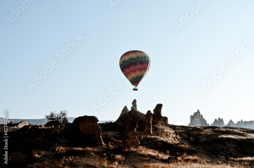 TURKEY, CAPPADOCIA, GOREME: Aerial scenic view of hot air balloons flying over mountains landscape with fairy chimneys