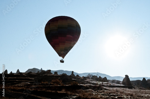 TURKEY, CAPPADOCIA, GOREME: Aerial scenic view of hot air balloons flying over mountains landscape with fairy chimneys