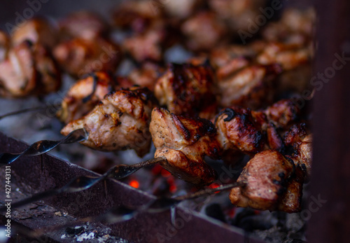 Grilled meat on skewers. Fresh shish kebab on skewers is fried on the grill. Cooking.