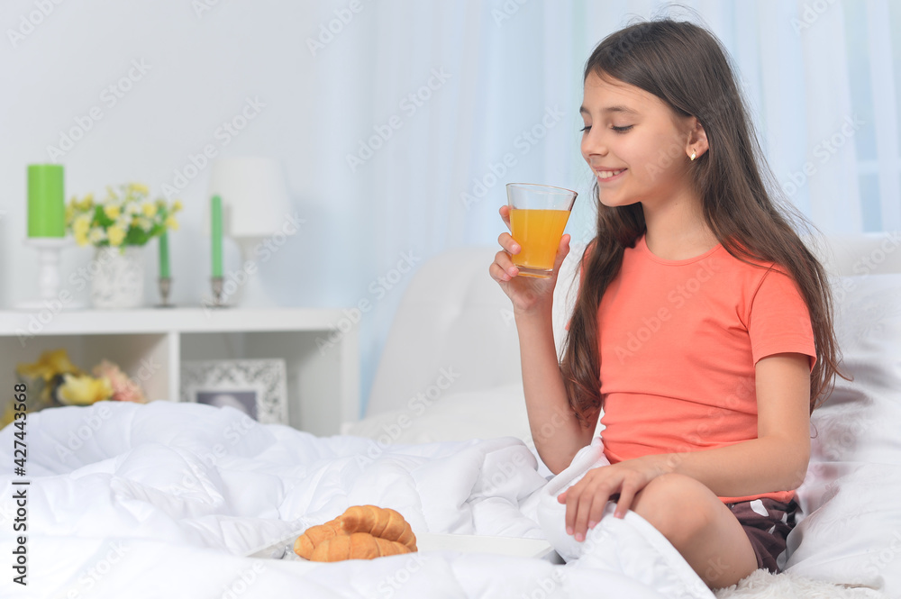 Cute girl with breakfast at home on bed Cute girl with breakfast at home on bed
