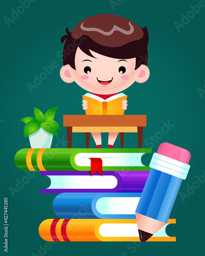 Happy Boy Reading Book On Stack Of Books