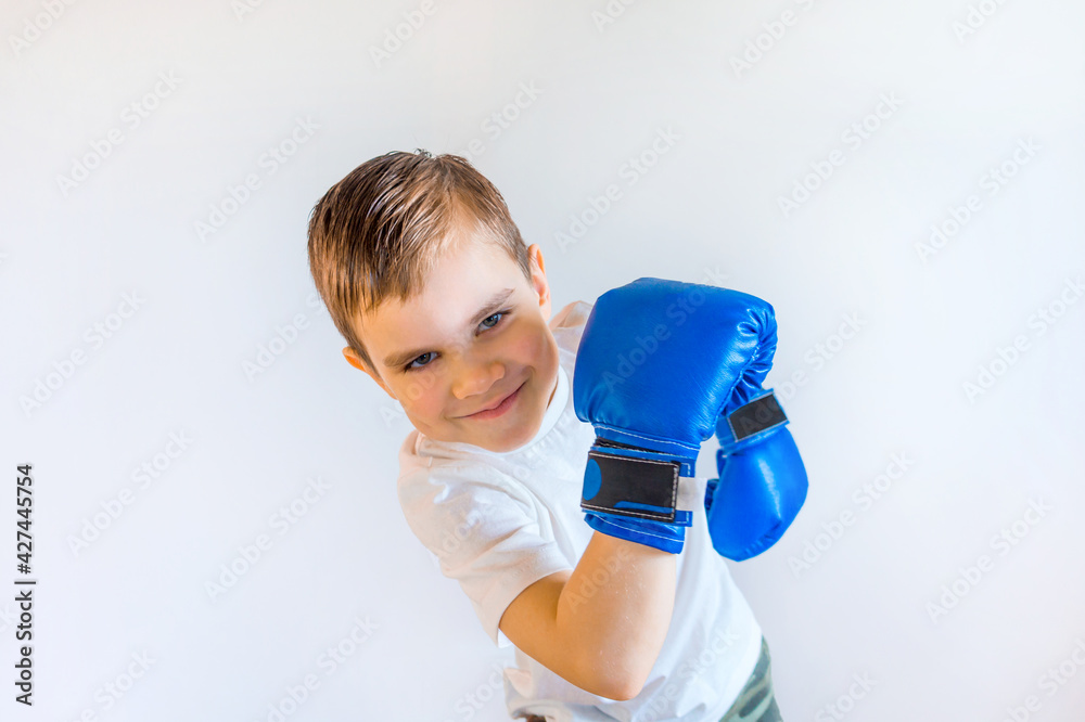 Smiling boy in boxing gloves ready to fight Smiling boy in boxing gloves ready to fight