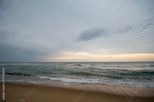 Waves at the ocean beach moody sky (ID: 427448315)