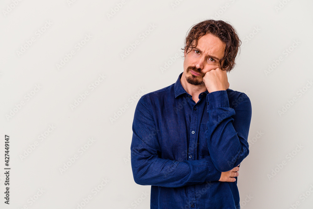 Young caucasian man isolated on white background who feels sad and pensive, looking at copy space. Young caucasian man isolated on white background who feels sad and pensive, looking at copy space.