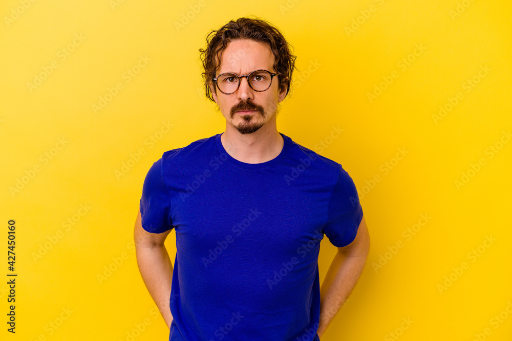 Young caucasian man isolated on yellow background sad, serious face, feeling miserable and displeased. Young caucasian man isolated on yellow background sad, serious face, feeling miserable and displeased.