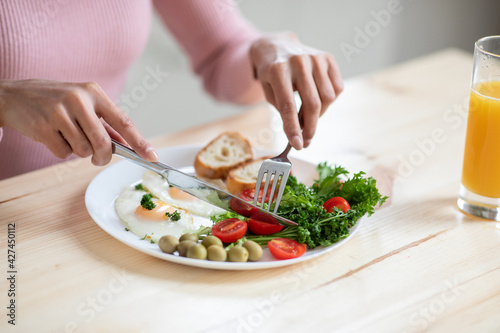 Closeup Shot Of Unrecognizable Lady Eating Tasty Breakfast At Table