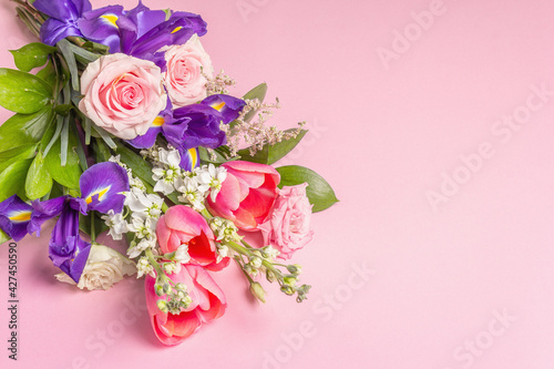 Fototapeta Naklejka Na Ścianę i Meble -  A beautiful bouquet of fresh flowers on a pink pastel background