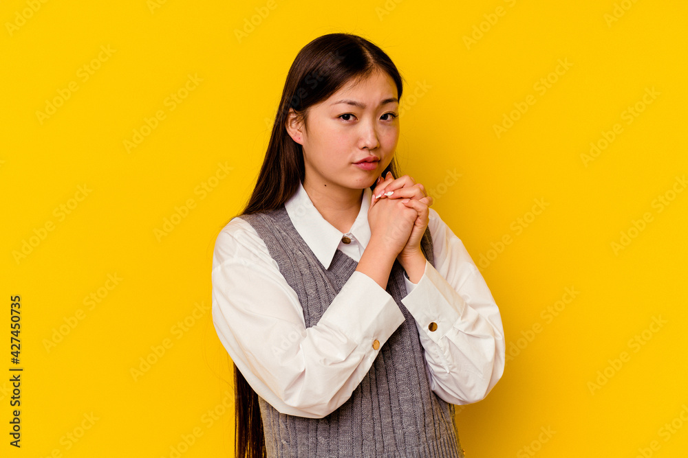 Young chinese woman isolated on yellow background scared and afraid. Young chinese woman isolated on yellow background scared and afraid.