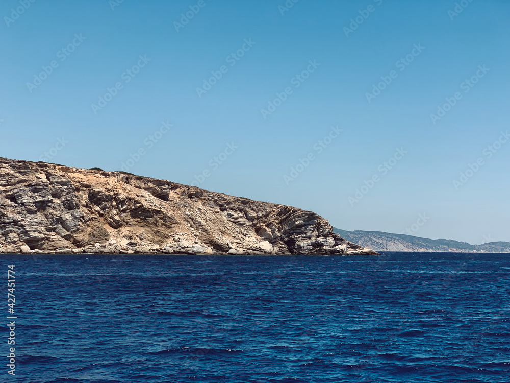 greek island hillside going into the Mediterranean Sea 