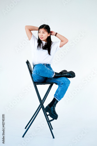 asian girl in jeans on a white background