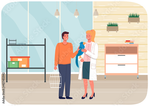 Veterinary care, treatment of parrots. Veterinarian wooman talking to owner with ara parrot