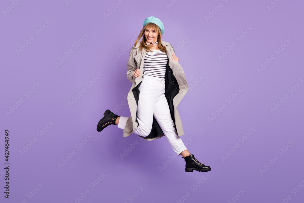 Photo of girl jump have fun shiny white smile wear blue beret coat pants shoes isolated violet color background Photo of girl jump have fun shiny white smile wear blue beret coat pants shoes isolated violet color background