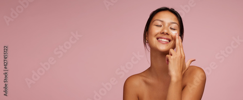 Youthful woman doing her skincare routine photo