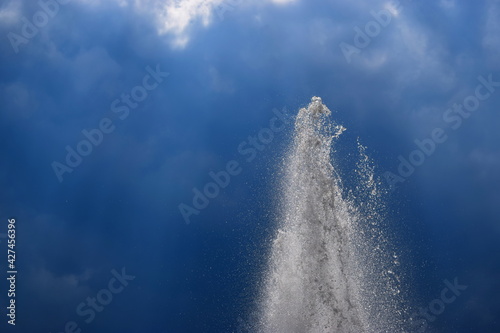 Top of the fountain on a background of dark blue cloudy sky