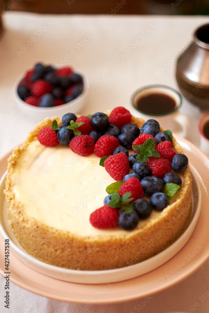 Cheesecake with berries on a white background. Side view. Cheesecake with berries on a white background. Side view.