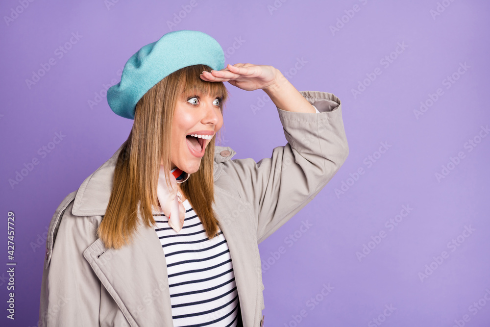 Photo of crazy lady look side empty space open mouth wear blue beret scarf coat isolated violet color background Photo of crazy lady look side empty space open mouth wear blue beret scarf coat isolated violet color background