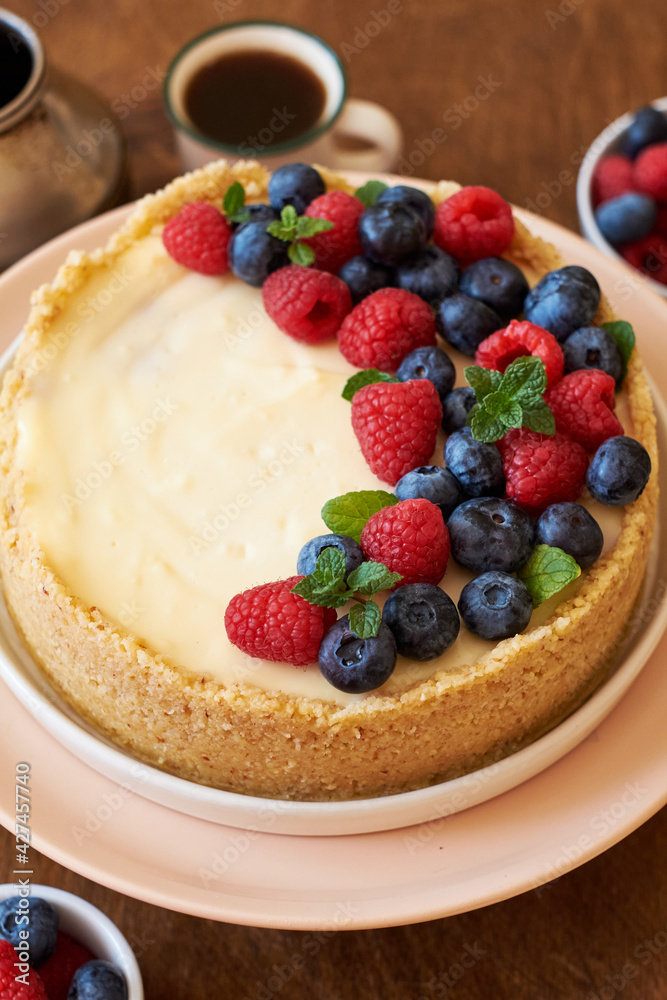 Cheesecake with berries on a wooden background. Side view. Cheesecake with berries on a wooden background. Side view.