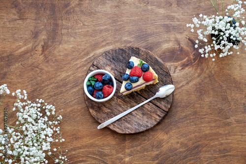 Cheesecake with berries on a wooden background. Top view.