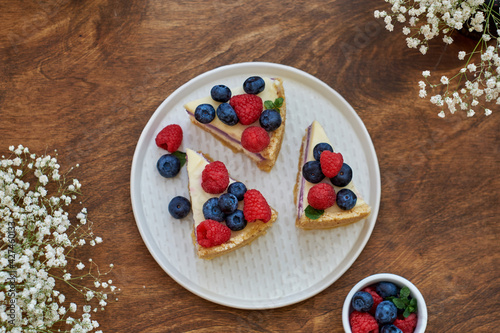 Cheesecake with berries on a wooden background. Top view.