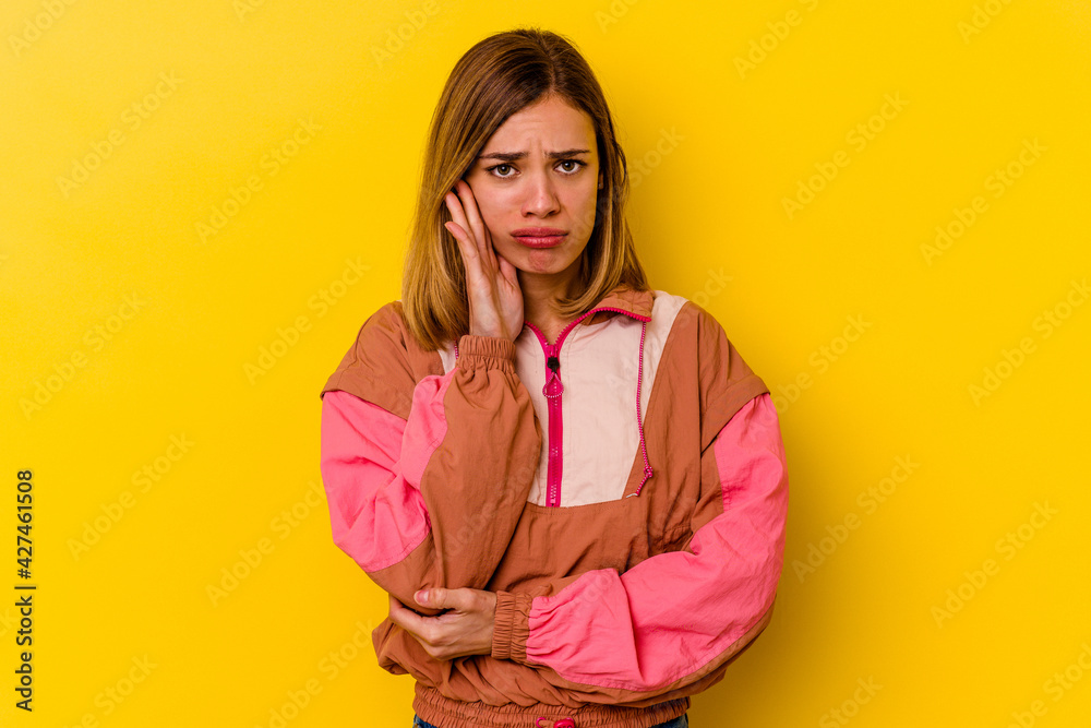 Young caucasian skinny woman isolated on yellow background blows cheeks, has tired expression. Facial expression concept. Young caucasian skinny woman isolated on yellow background blows cheeks, has tired expression. Facial expression concept.