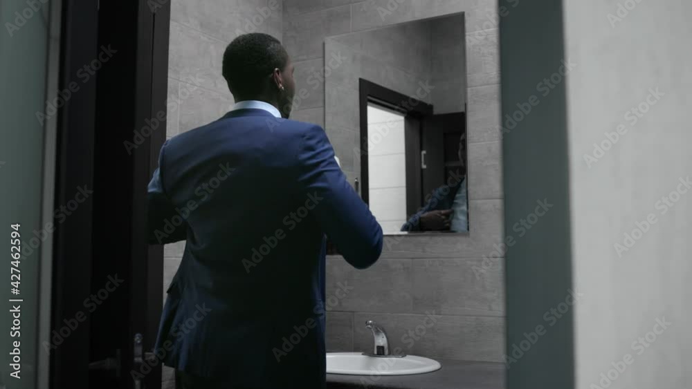 The business man walks down the hallway to the office. The business man walks down the hallway to the office.