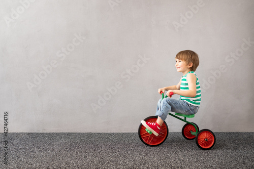 Fotografie Happy child riding vintage trike