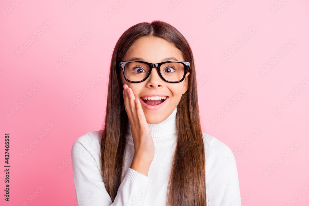 Photo of shiny funny schoolgirl dressed white sweater glasses arm cheek isolated pink color background