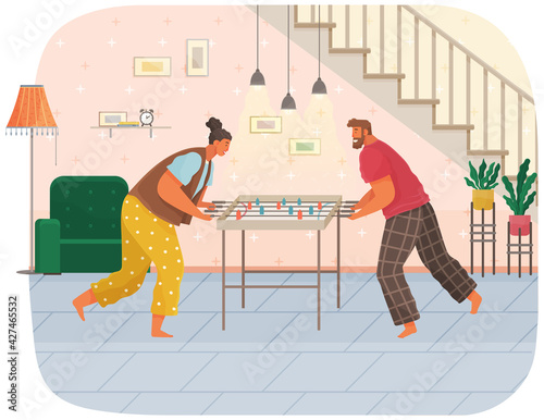 Cheerful couple with board game. Man and woman play table football together in room near stairs