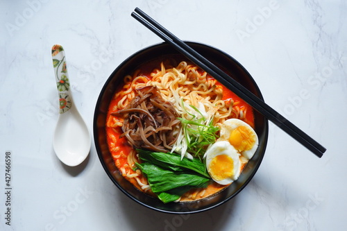 a bowl of spicy noodle with various topping or known as  ramen  photo