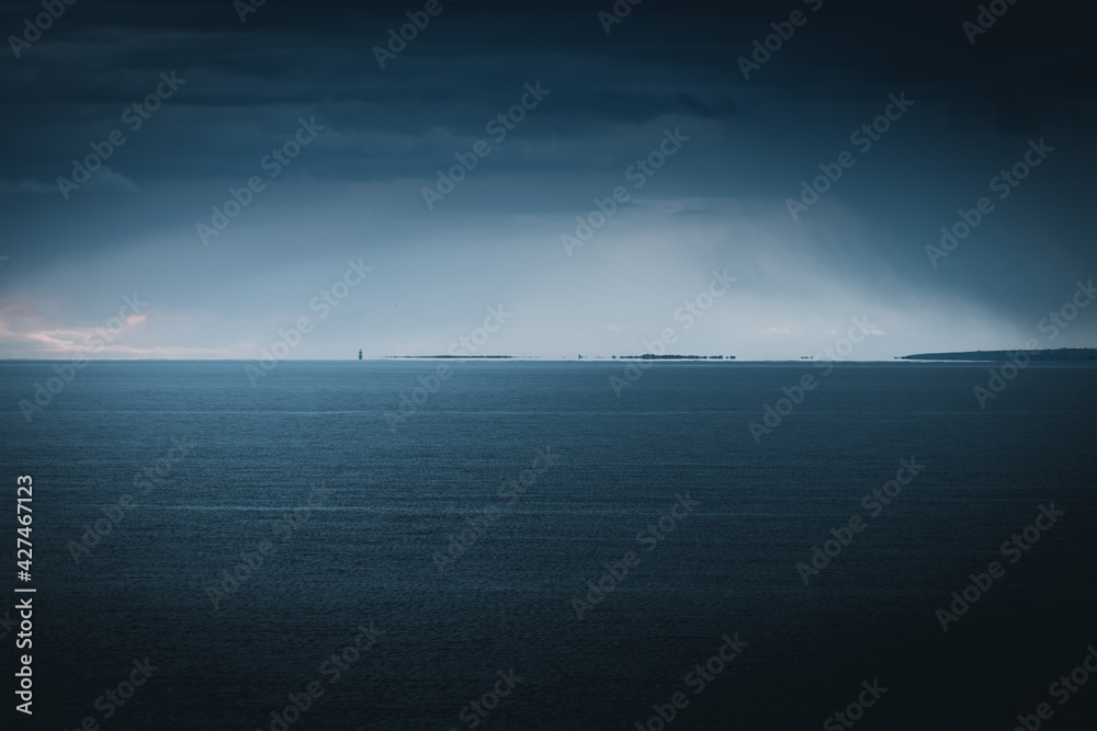 storm over the sea and hook head lighthouse in the distance storm over the sea and hook head lighthouse in the distance