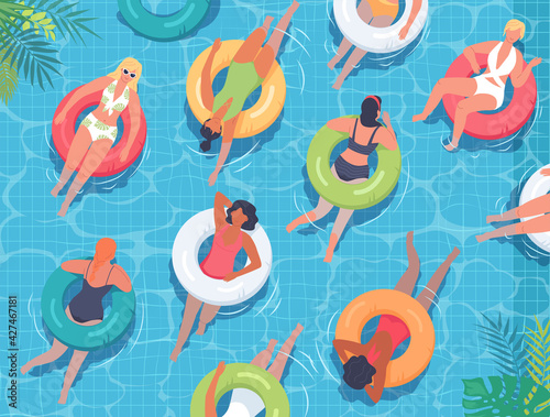 Women swimming in the pool with colorful lifebuoys 