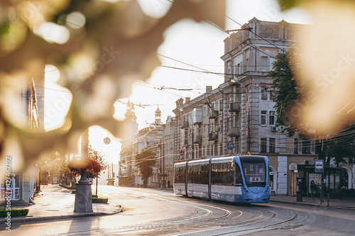 Fényképezés Morning central street of the city with a new tram passing on it