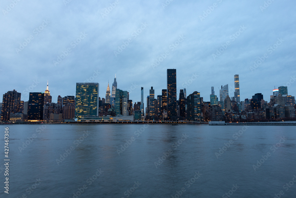 Evening Midtown Manhattan Skyline along the East River in New York City Evening Midtown Manhattan Skyline along the East River in New York City