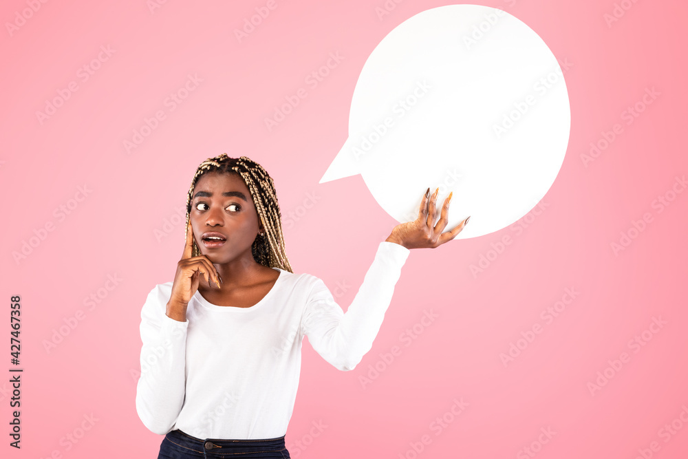 Pensive afro woman holding speech bubble at studio Pensive afro woman holding speech bubble at studio