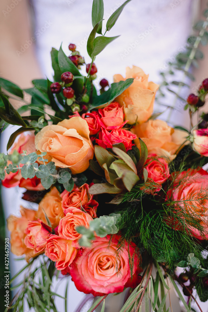 Fototapeta premium Bride holds beautiful vibrant wedding bouquet