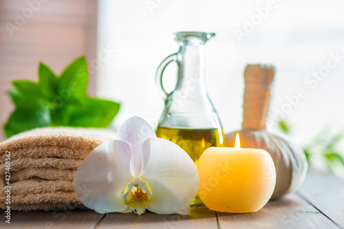 Spa background. Towel  candles  orchid flowers and herbal balls. Massage  oriental therapy  wellbeing and meditation.