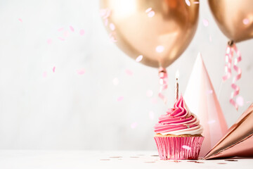 Birthday celebration with cupcake and balloons