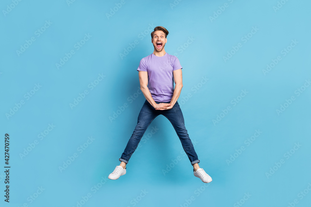 Full size portrait of carefree excited guy open mouth have fun look camera isolated on blue color background