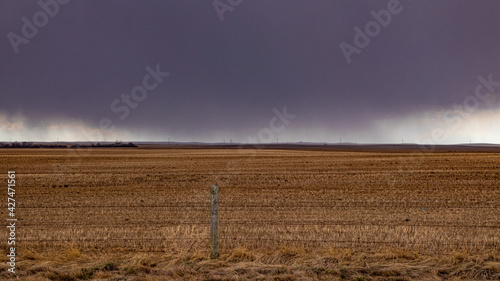 Dark clouds over a farmers field, a spring storm in the prairies