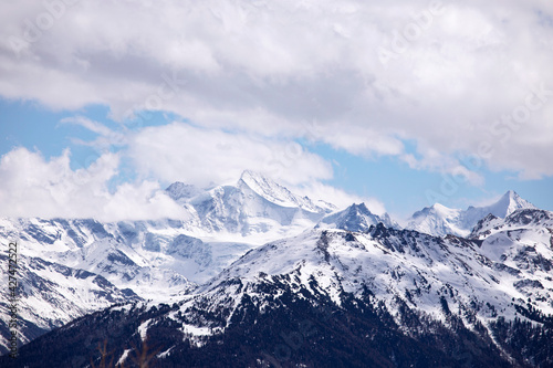 Fototapeta Naklejka Na Ścianę i Meble -  Winter landscape snowy mountains, sky and clouds. Mountain peaks in Swiss alps, Wallis.