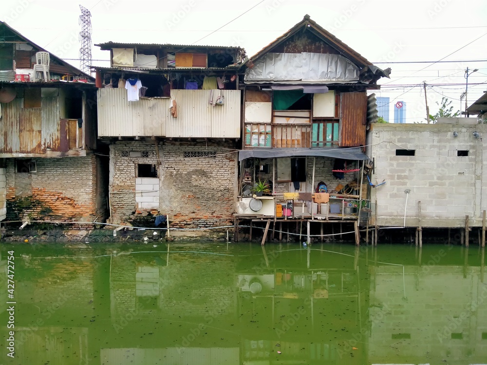 Sungai Duri, Roxy mas, Jakarta, Indonesia - (04-03-2021) :The atmosphere of a densely populated settlement standing on the river bank Sungai Duri, Roxy mas, Jakarta, Indonesia - (04-03-2021) :The atmosphere of a densely populated settlement standing on the river bank