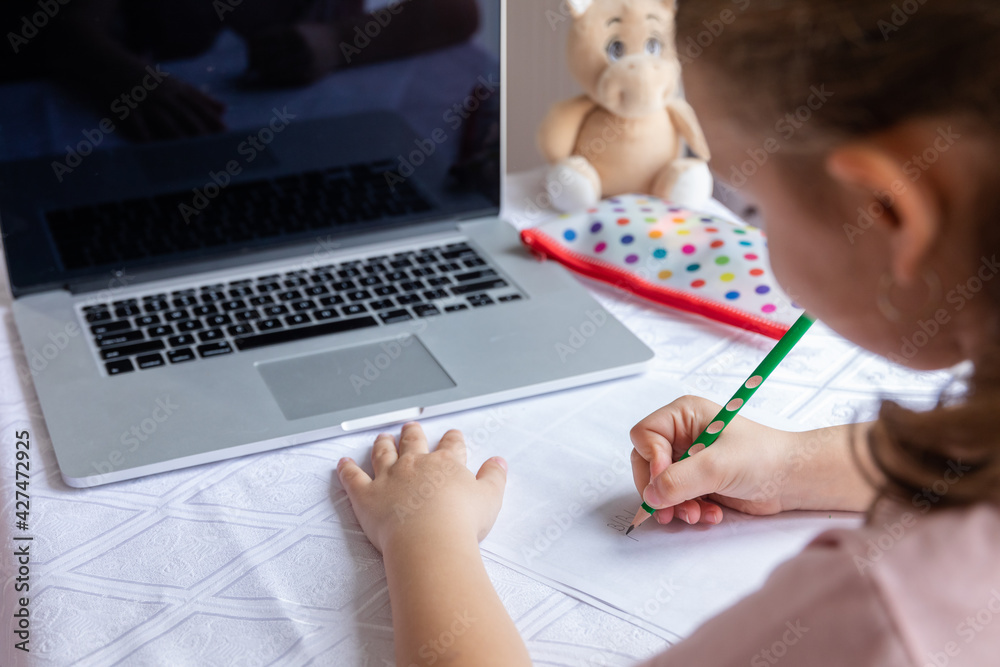 Little girl is back to school with the mask on her face, online education Little girl is back to school with the mask on her face, online education