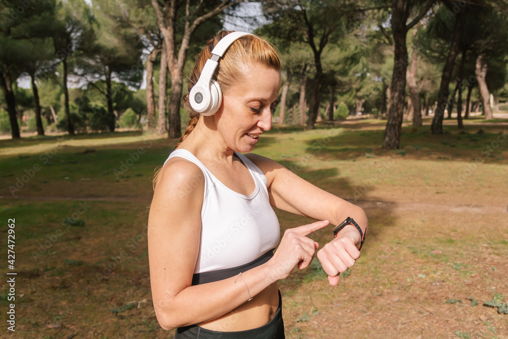 Horizontal image of a Hispanic runner training with a smart watch. Lifestyle concept Horizontal image of a Hispanic runner training with a smart watch. Lifestyle concept