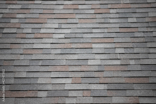 roof shingle background and texture. dark asphalt tiles on the roof