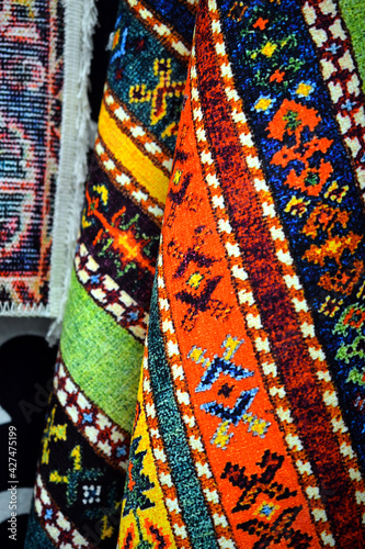 carpets for sale on a market, design patterns of a rug © bellakadife