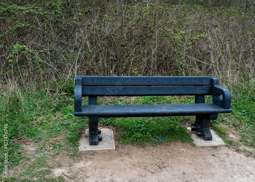 A new black hard plastic bench in a norfolk park