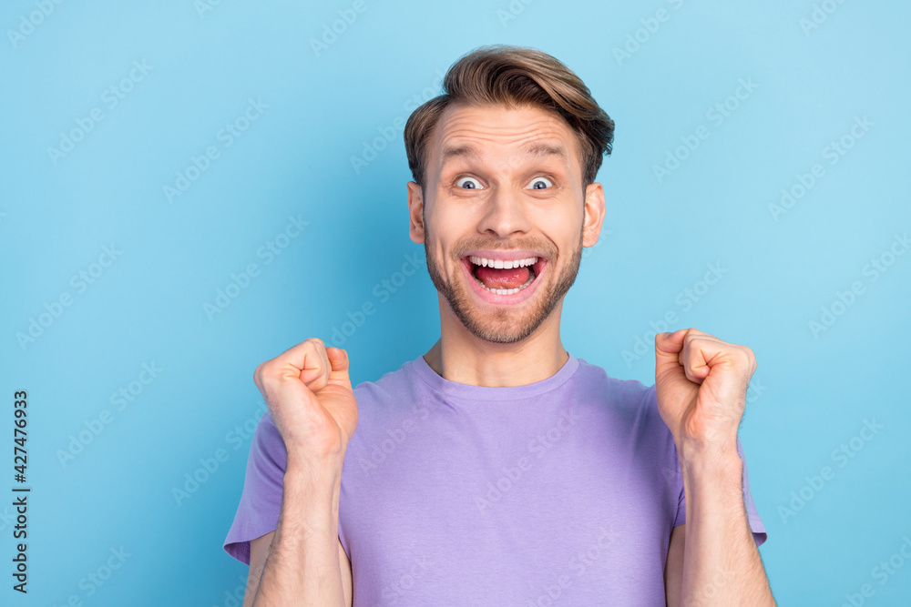 Photo portrait of man overjoyed amazed gesturing like money winner isolated on pastel blue color background Photo portrait of man overjoyed amazed gesturing like money winner isolated on pastel blue color background